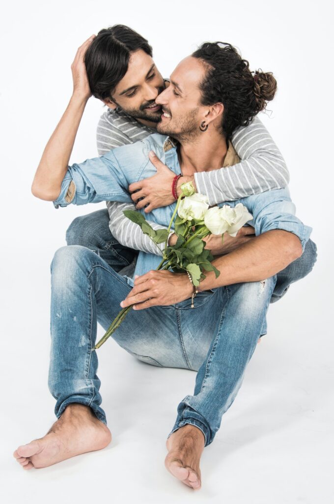Gay Couple hugging seated