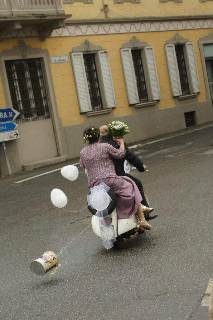 Old persons marriage leaving on a scooter